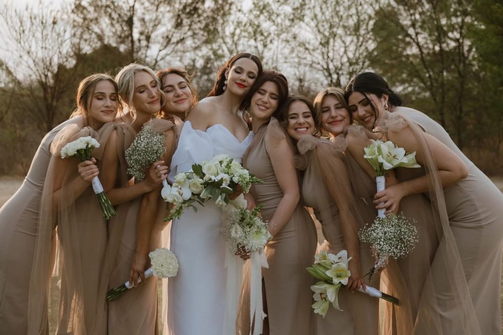 Bride and bridesmaids posing in garden area at Simbali