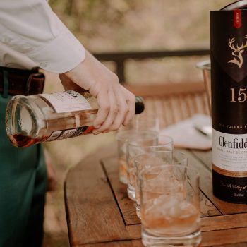 Groom and groomsmen sharing a toast in Simbali Groom Suite