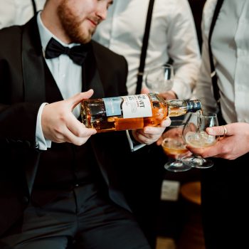 Groom and groomsmen sharing a toast in Simbali Groom Suite